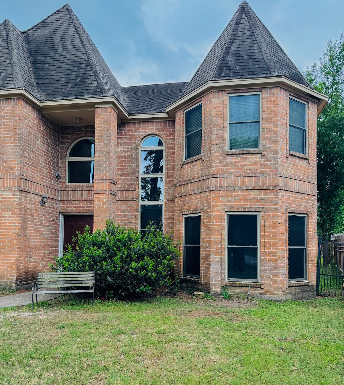 Completed WinChoice window installation on a two-story brick home